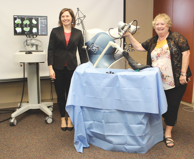 Dr. Willson poses with Judy Roach, the first mclaren flint patient to have a Mako robotic-arm assisted partial knee replacement.