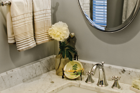 The gray walls and Italian marble vanity pick up the gray in the drapery fabric.
